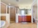 Modern bathroom with a shower, bathtub, double vanity, and tile flooring at 20100 Ragazza Cir # 101, Venice, FL 34293