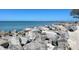 Scenic view of a rocky beach shoreline with clear blue water at 20100 Ragazza Cir # 101, Venice, FL 34293