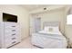 Bedroom featuring a dresser, TV, and comfy bed with carpeted floors at 20100 Ragazza Cir # 101, Venice, FL 34293