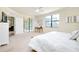 Spacious bedroom with a king-size bed, ceiling fan, and access to a patio at 20100 Ragazza Cir # 101, Venice, FL 34293