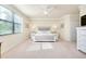 Large bedroom with a king-size bed, ceiling fan, and windows with blinds at 20100 Ragazza Cir # 101, Venice, FL 34293