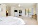 Bright bedroom with king-size bed, access to a patio, and ensuite bathroom at 20100 Ragazza Cir # 101, Venice, FL 34293