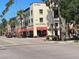 Historic building with red awnings and palm trees lining the street at 20100 Ragazza Cir # 101, Venice, FL 34293