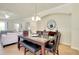 Dining space featuring a glass-top table, black leather chairs, and a decorative mirror under a modern light fixture at 20100 Ragazza Cir # 101, Venice, FL 34293