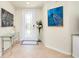 Welcoming foyer with tiled floor, stylish decor, and natural light from the glass-paned front door at 20100 Ragazza Cir # 101, Venice, FL 34293