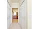 Hallway leading to a well-lit bathroom with double sinks and cabinets at 20100 Ragazza Cir # 101, Venice, FL 34293