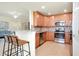 Modern kitchen featuring stainless steel appliances and wood cabinetry at 20100 Ragazza Cir # 101, Venice, FL 34293