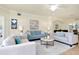 Open living room with two sofas, a marble coffee table, and access to the dining area at 20100 Ragazza Cir # 101, Venice, FL 34293