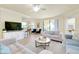 Spacious living area featuring comfortable seating, a coffee table, and a large TV at 20100 Ragazza Cir # 101, Venice, FL 34293
