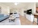Modern living area with comfortable sofas, stylish decor, and a view of the dining room at 20100 Ragazza Cir # 101, Venice, FL 34293