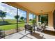 Relaxing screened porch with outdoor furniture and scenic views at 20100 Ragazza Cir # 101, Venice, FL 34293