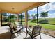 Screened-in porch overlooking green space with seating area at 20100 Ragazza Cir # 101, Venice, FL 34293