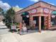Pink storefront with a mermaid statue and open sign at 20100 Ragazza Cir # 101, Venice, FL 34293