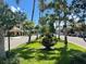 Tree-lined street with shops and a central flower-filled planter at 20100 Ragazza Cir # 101, Venice, FL 34293