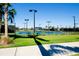 Tennis court with blue surface and green surroundings at 20100 Ragazza Cir # 101, Venice, FL 34293