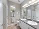 Guest bathroom with double sinks and granite countertop at 2049 Mesic Hammock Way, Venice, FL 34292