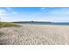 Scenic beach view with a pier in the distance at 2049 Mesic Hammock Way, Venice, FL 34292