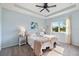 Main bedroom with light blue walls and a ceiling fan at 2049 Mesic Hammock Way, Venice, FL 34292