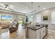 Open concept kitchen with granite island, stainless steel appliances, and breakfast bar at 2049 Mesic Hammock Way, Venice, FL 34292