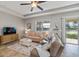 Bright living room with lake view, comfortable seating, and a large TV at 2049 Mesic Hammock Way, Venice, FL 34292