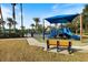 playground with shaded areas and a bench nearby at 2049 Mesic Hammock Way, Venice, FL 34292