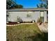 Charming single-story home featuring a well-manicured lawn and decorative potted plants at 2191 Park Rd, Venice, FL 34293