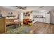 Open concept living area with hardwood floors, neutral walls, and seamlessly connects to the kitchen at 2191 Park Rd, Venice, FL 34293