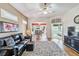 Open living room with hardwood floors, a leather sofa, a glimpse into the dining room, and a view of the bedroom at 2232 Lynx Run, North Port, FL 34286