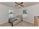 Bedroom with ceiling fan, large windows, and light wood floors at 23167 Turnbull Ave, Port Charlotte, FL 33954