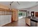 Kitchen with view of backyard pool and patio. Features wood cabinets and tile flooring at 23167 Turnbull Ave, Port Charlotte, FL 33954