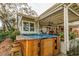 Hot tub with wooden enclosure and bar stools at 2420 Butternut Ct, Dunedin, FL 34698