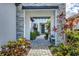 Stone walkway leading to front door with lush landscaping at 245 Corelli Dr, Nokomis, FL 34275