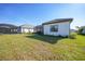Lush backyard featuring a well-kept lawn and mature landscaping at 26069 Norman Dr, Englewood, FL 34223