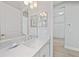 Bright bathroom with a double vanity, modern fixtures, and access to storage and closet space at 26069 Norman Dr, Englewood, FL 34223
