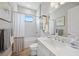 Clean and bright bathroom featuring white vanity, bathtub and tile shower at 26069 Norman Dr, Englewood, FL 34223