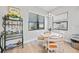 Breakfast area with white table and chairs next to window with black blinds at 26069 Norman Dr, Englewood, FL 34223