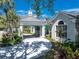 Elegant porte cochere showcasing a covered entrance with meticulous landscaping and architectural details at 26069 Norman Dr, Englewood, FL 34223