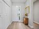Bright foyer with a clean, modern aesthetic, featuring wood floors and a white front door at 26069 Norman Dr, Englewood, FL 34223