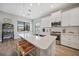 Stylish kitchen features a large island with seating, pendant lighting, and modern appliances at 26069 Norman Dr, Englewood, FL 34223