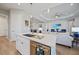 Open-concept kitchen with a large island, modern appliances, and seamless flow to the living area at 26069 Norman Dr, Englewood, FL 34223