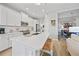 Well-lit open kitchen featuring an island with seating, and stainless steel appliances at 26069 Norman Dr, Englewood, FL 34223