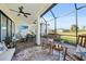Relaxing screened lanai with ceiling fan, rocking chairs and outdoor seating at 26069 Norman Dr, Englewood, FL 34223
