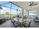 Screened in lanai area with outdoor dining table and beautiful view at 26069 Norman Dr, Englewood, FL 34223