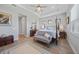 Bright main bedroom with a four-poster bed, bench, wood floors, and decorative details at 26069 Norman Dr, Englewood, FL 34223