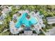 Aerial view of a stunning, resort-style pool area surrounded by lush landscaping and plenty of lounge chairs at 26069 Norman Dr, Englewood, FL 34223