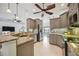 Modern kitchen with gray cabinets, granite countertops, and stainless steel appliances at 2665 Alamander Ave, Englewood, FL 34223