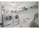 Bright laundry room with washer, dryer, and utility sink at 2665 Alamander Ave, Englewood, FL 34223