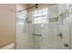 Shower with marble tile, glass enclosure, and built-in shelving at 275 Royal Oak Way, Venice, FL 34292