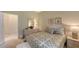 Bright bedroom with a queen bed and light-colored decor at 275 Royal Oak Way, Venice, FL 34292