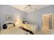Bedroom with twin beds, light blue walls, and ceiling fan at 275 Royal Oak Way, Venice, FL 34292